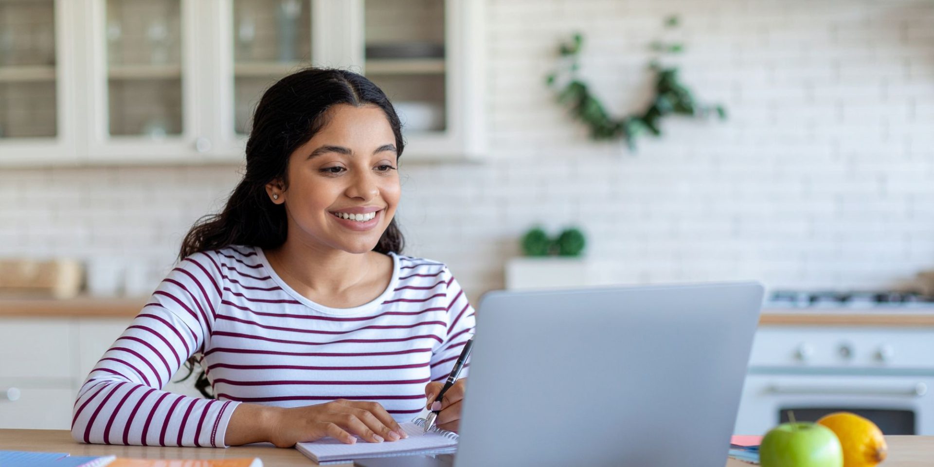 adult woman sitting with laptop during online class