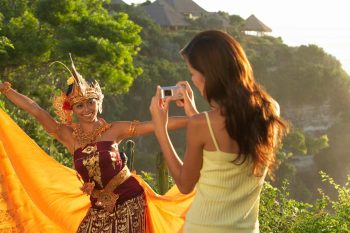 Wonam taking photo od Indonesian woman in national dress