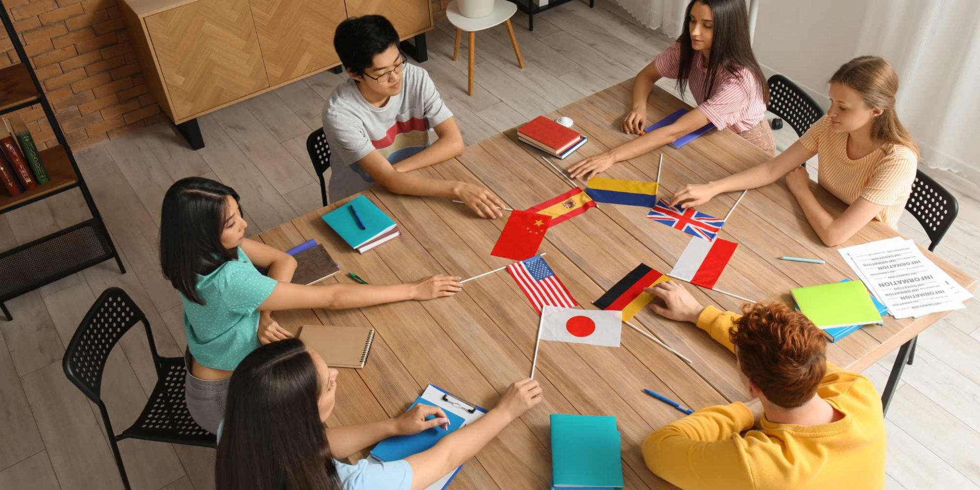 people sitting around the table with different countries flags