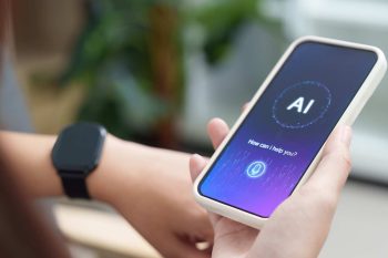 human hand holding smartphone witi AI on the screen