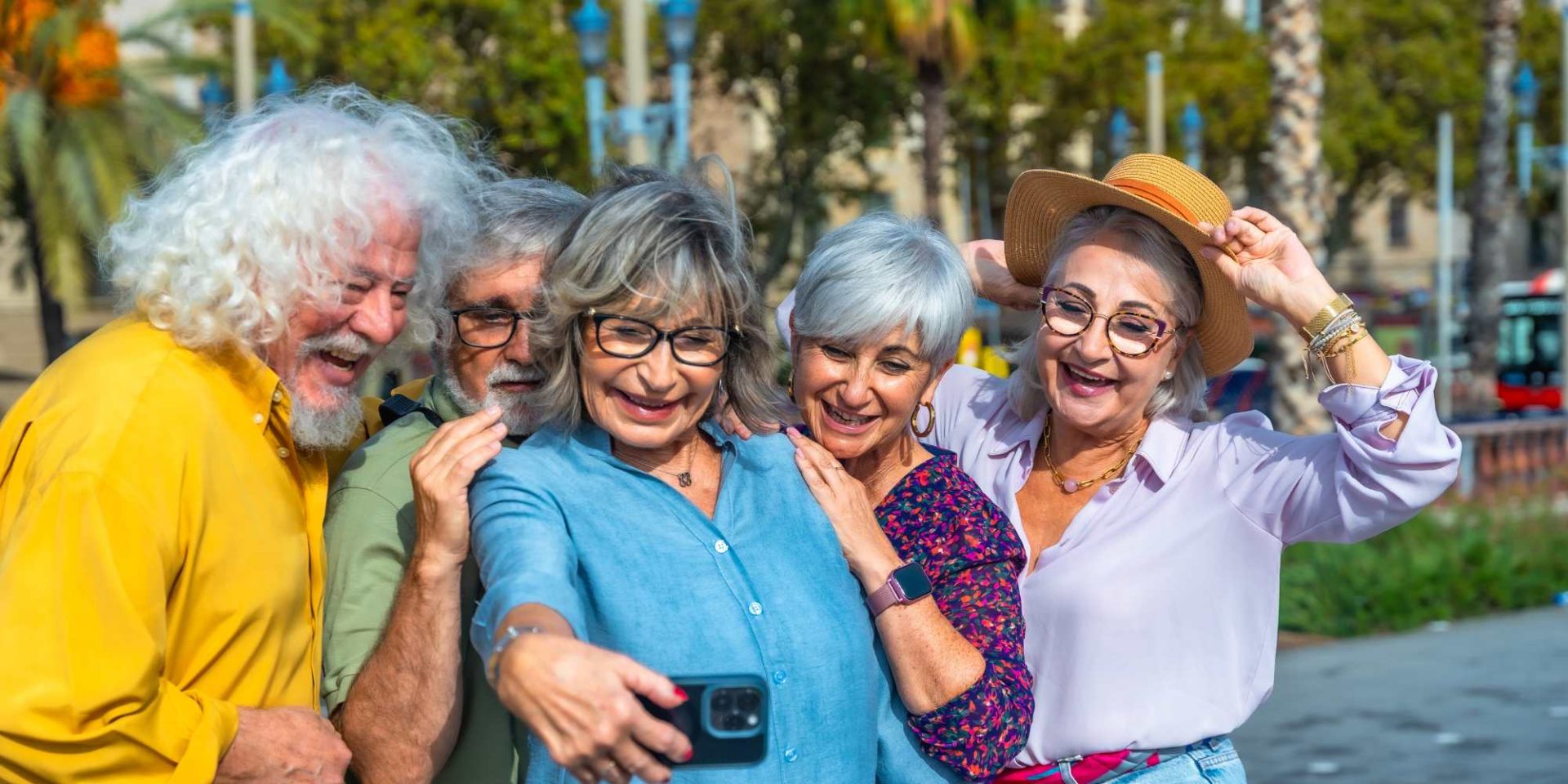 a group of seniors taking photo on smartphone