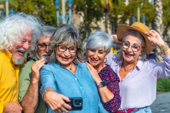 a group of seniors taking photo on smartphone