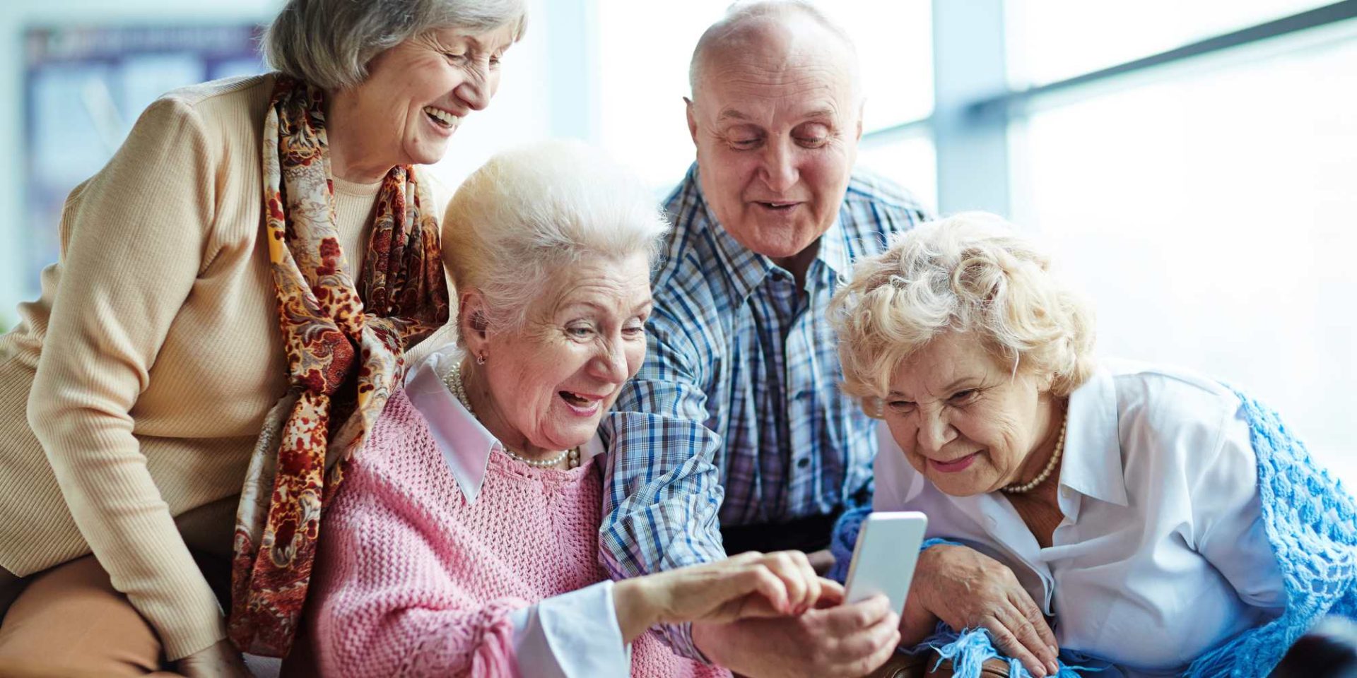 a group of seniors people looking at smartphone