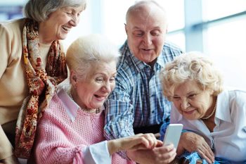 a group of seniors people looking at smartphone