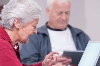 senior man and woman using laptopn