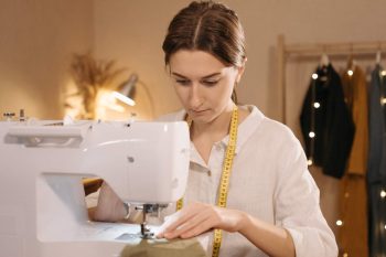 A student adjusting a dress pattern
