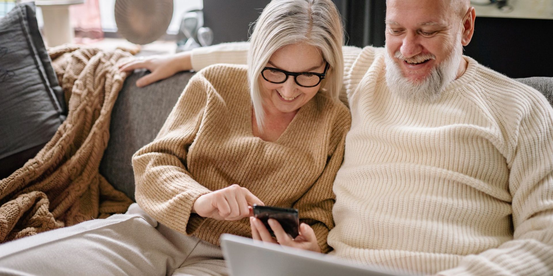 senior man and woman using smartphone to make a call